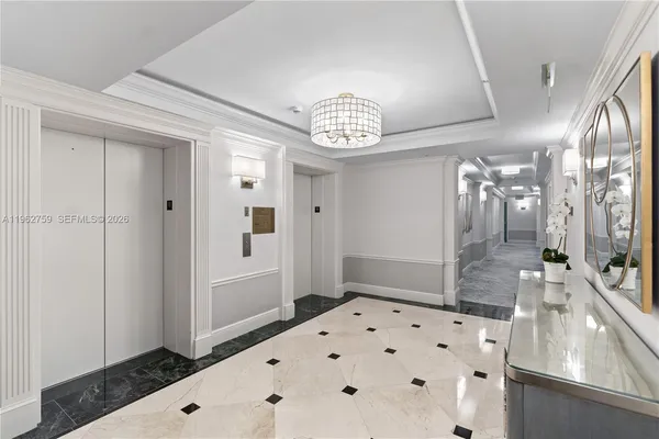 a view of a hallway with cabinet and wooden floor