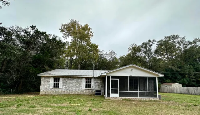 a house with green field in front of it