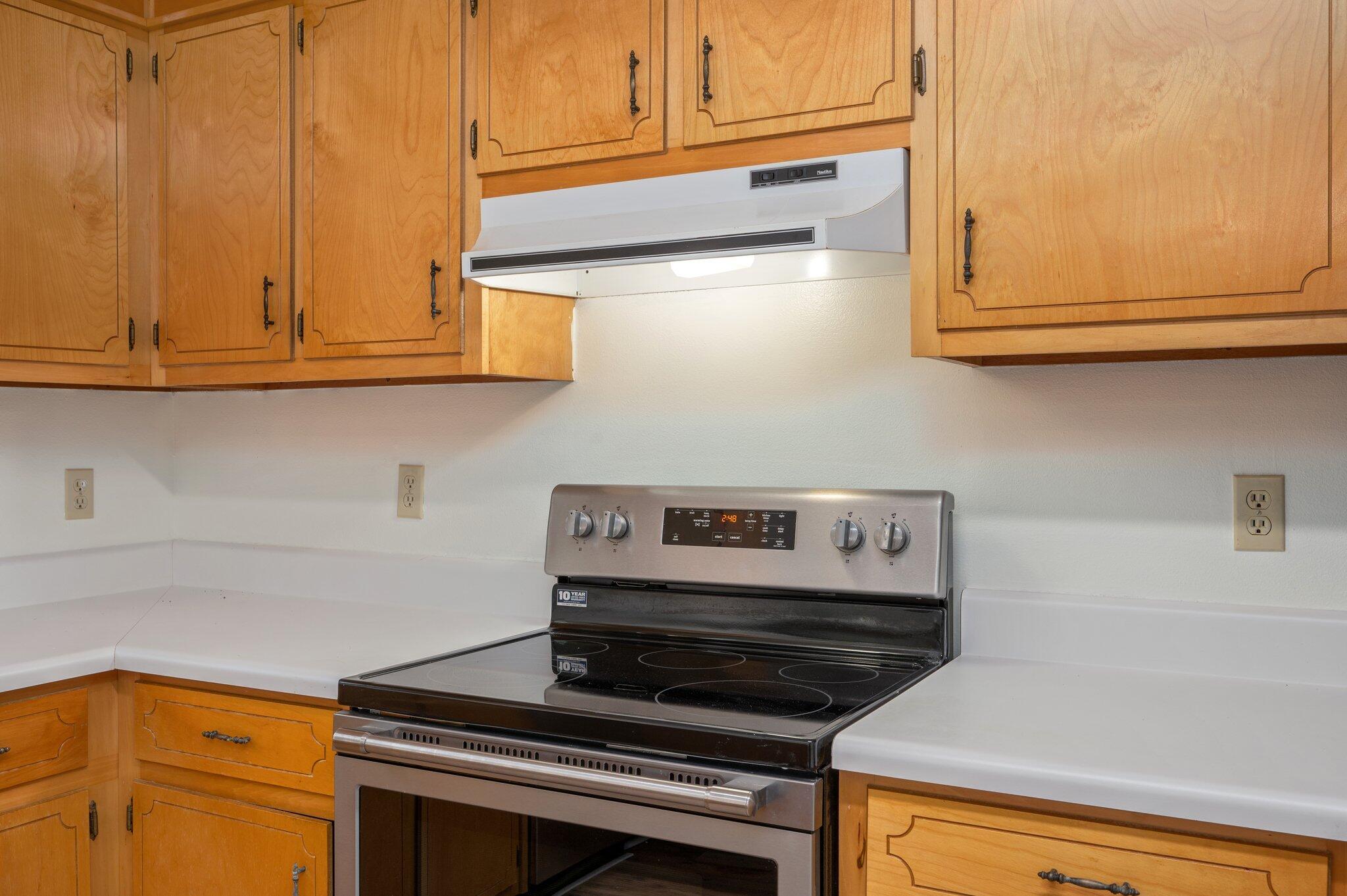 624 Hill Street DeFuniak Springs, FL 32435 - Photo 13 of 34 a kitchen with wooden cabinets and a stove top oven