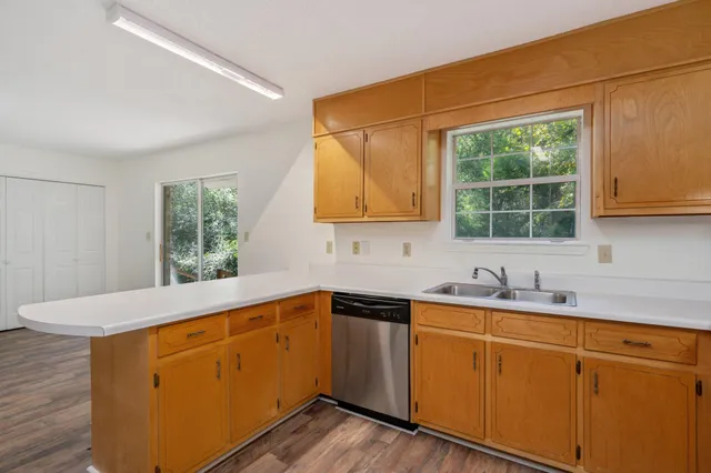a kitchen with sink cabinets and window