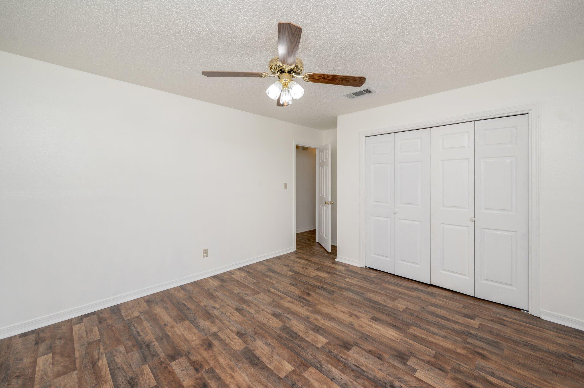 624 Hill Street DeFuniak Springs, FL 32435 - Photo 19 of 34 a view of an empty room with wooden floor