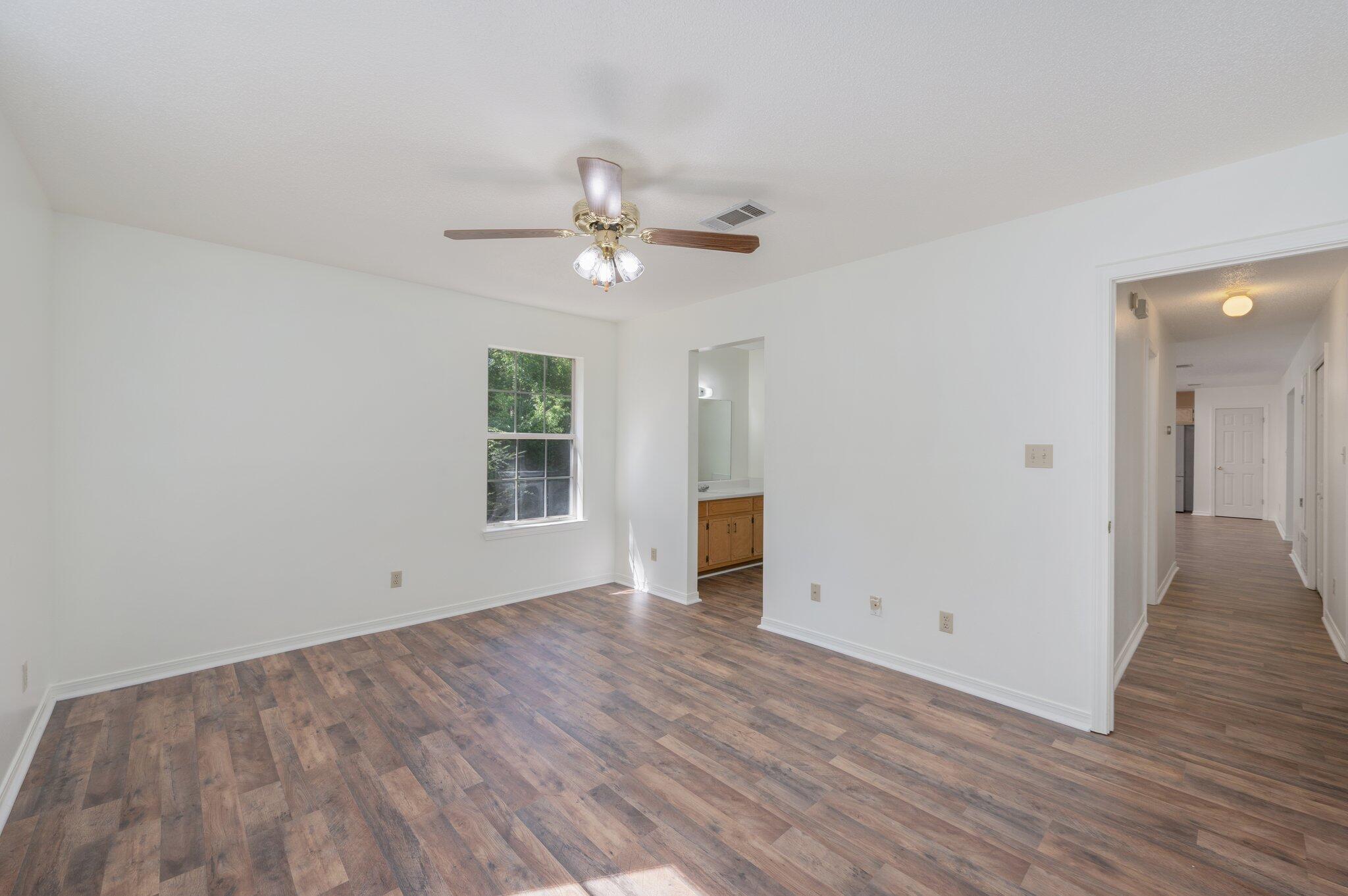624 Hill Street DeFuniak Springs, FL 32435 - Photo 23 of 34 wooden floor in an empty room with a window