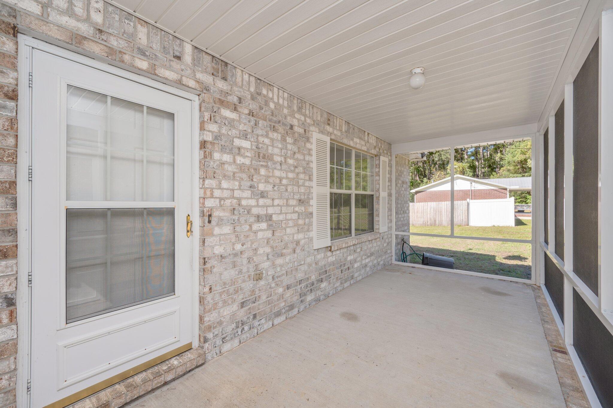 624 Hill Street DeFuniak Springs, FL 32435 - Photo 5 of 34 a view of an empty room with a fireplace and a window