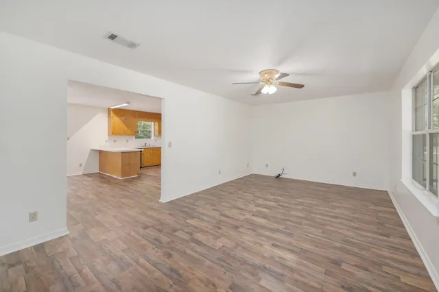 wooden floor in an empty room with a window