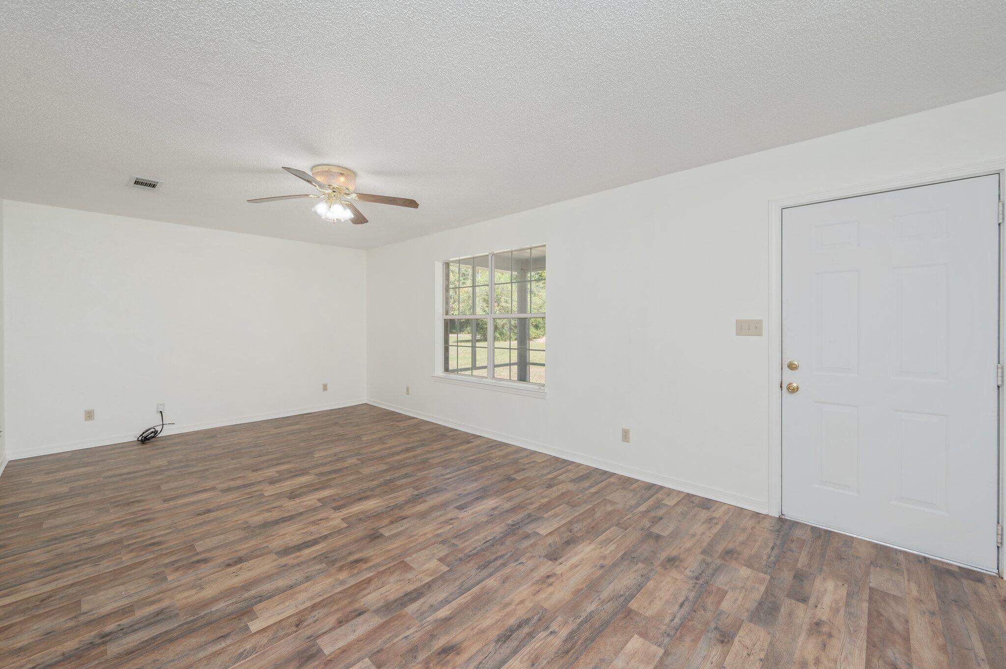 624 Hill Street DeFuniak Springs, FL 32435 - Photo 7 of 34 an empty room with fan and windows