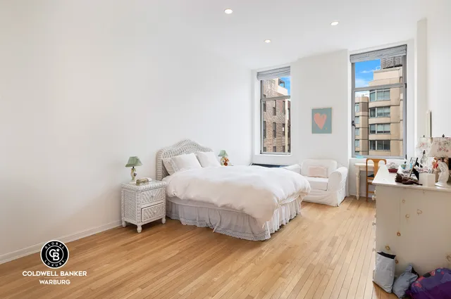 a bedroom with a bed and a chair