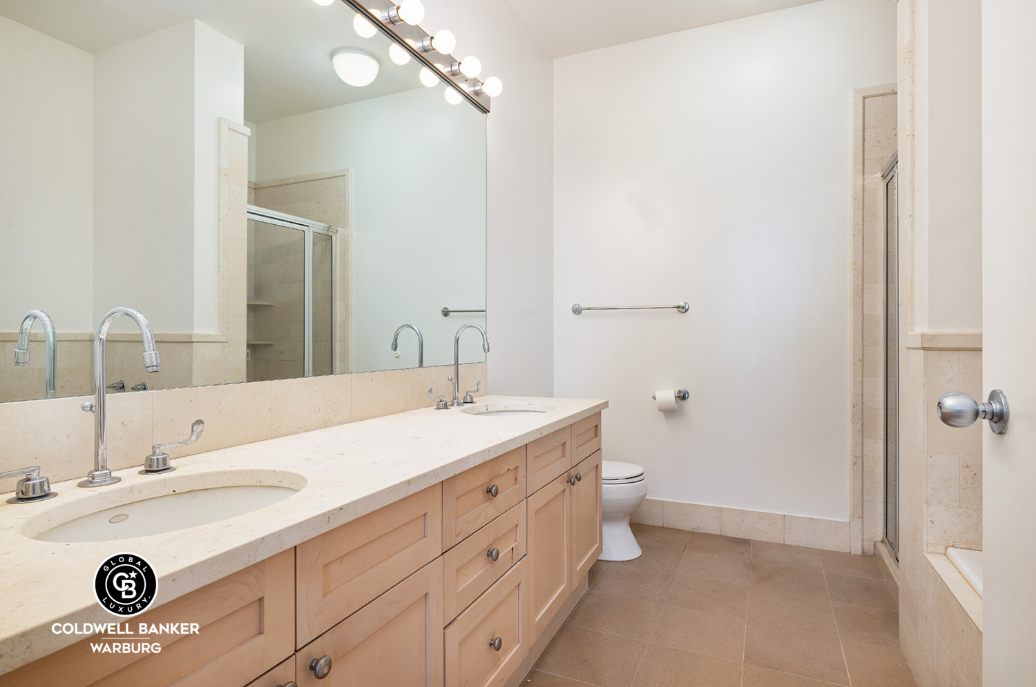 252 7th Avenue, Unit 12I Manhattan, NY 10001 - Photo 10 of 15 a bathroom with a sink double vanity and a mirror