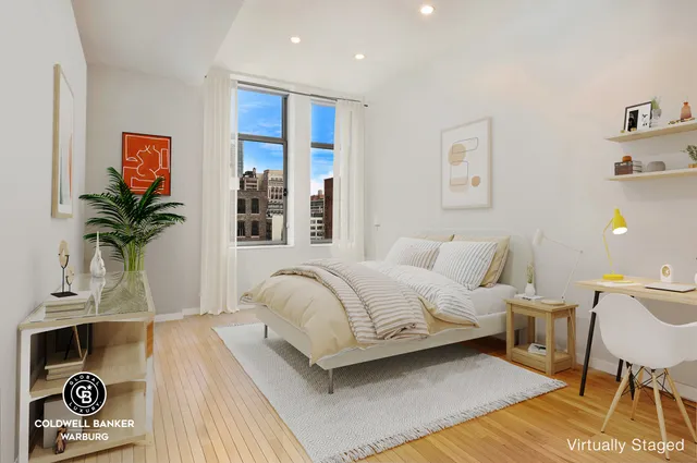 a bedroom with two beds and painting on the wall