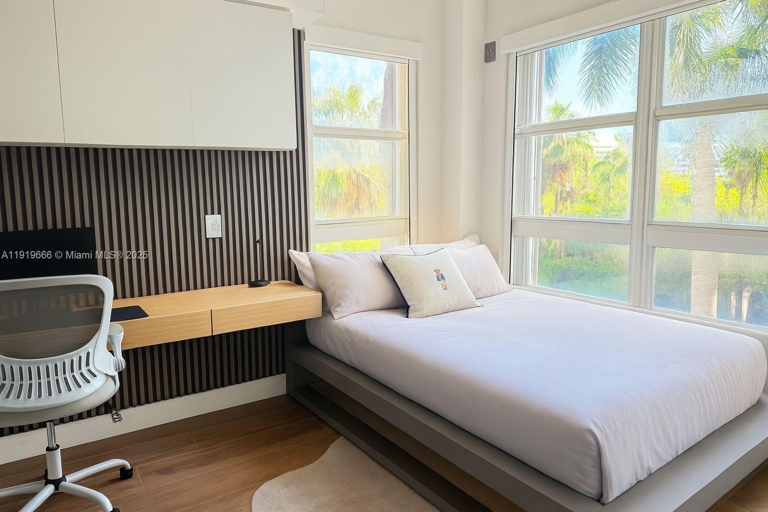 711 Crandon Boulevard, Unit 401 Key Biscayne, FL 33149 - Photo 11 of 29 a bedroom with a bed and a window