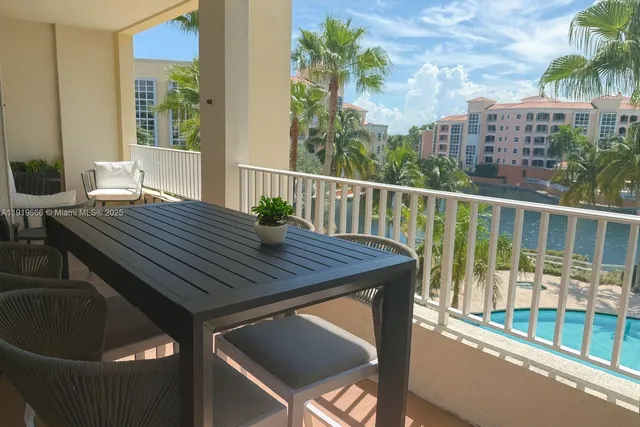 a view of a balcony with two chairs and a table