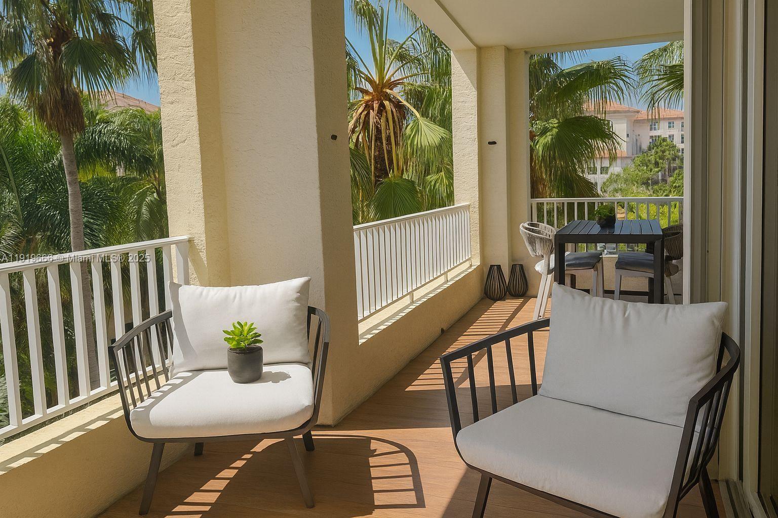 711 Crandon Boulevard, Unit 401 Key Biscayne, FL 33149 - Photo 16 of 29 a view of a chairs and table in a balcony