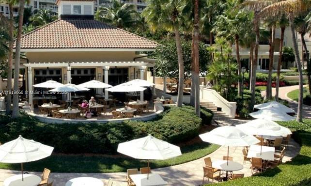 711 Crandon Boulevard, Unit 401 Key Biscayne, FL 33149 - Photo 23 of 29 a view of a table and chairs in backyard
