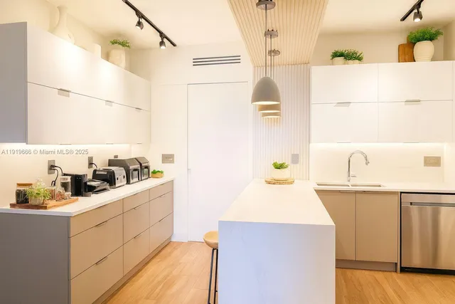 a kitchen with a sink a stove and cabinets