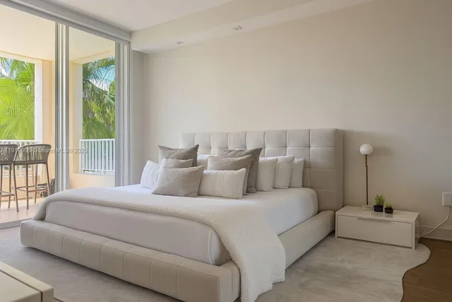 a bedroom with bed and a large window