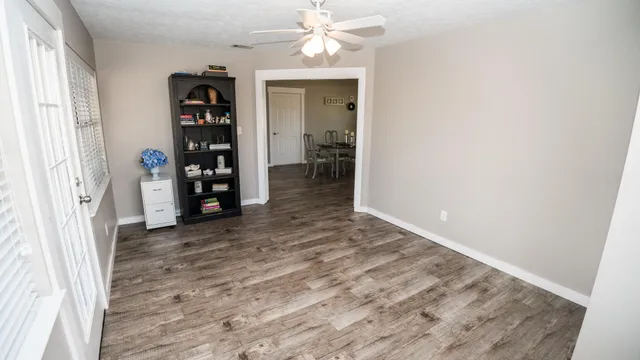 wooden floor in an empty room with a window