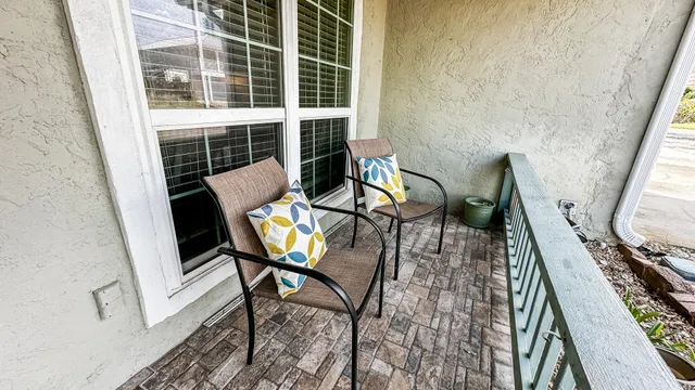 a view of a balcony with furniture
