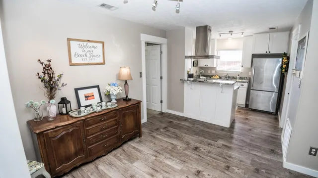 a kitchen with stainless steel appliances a refrigerator and a stove top oven