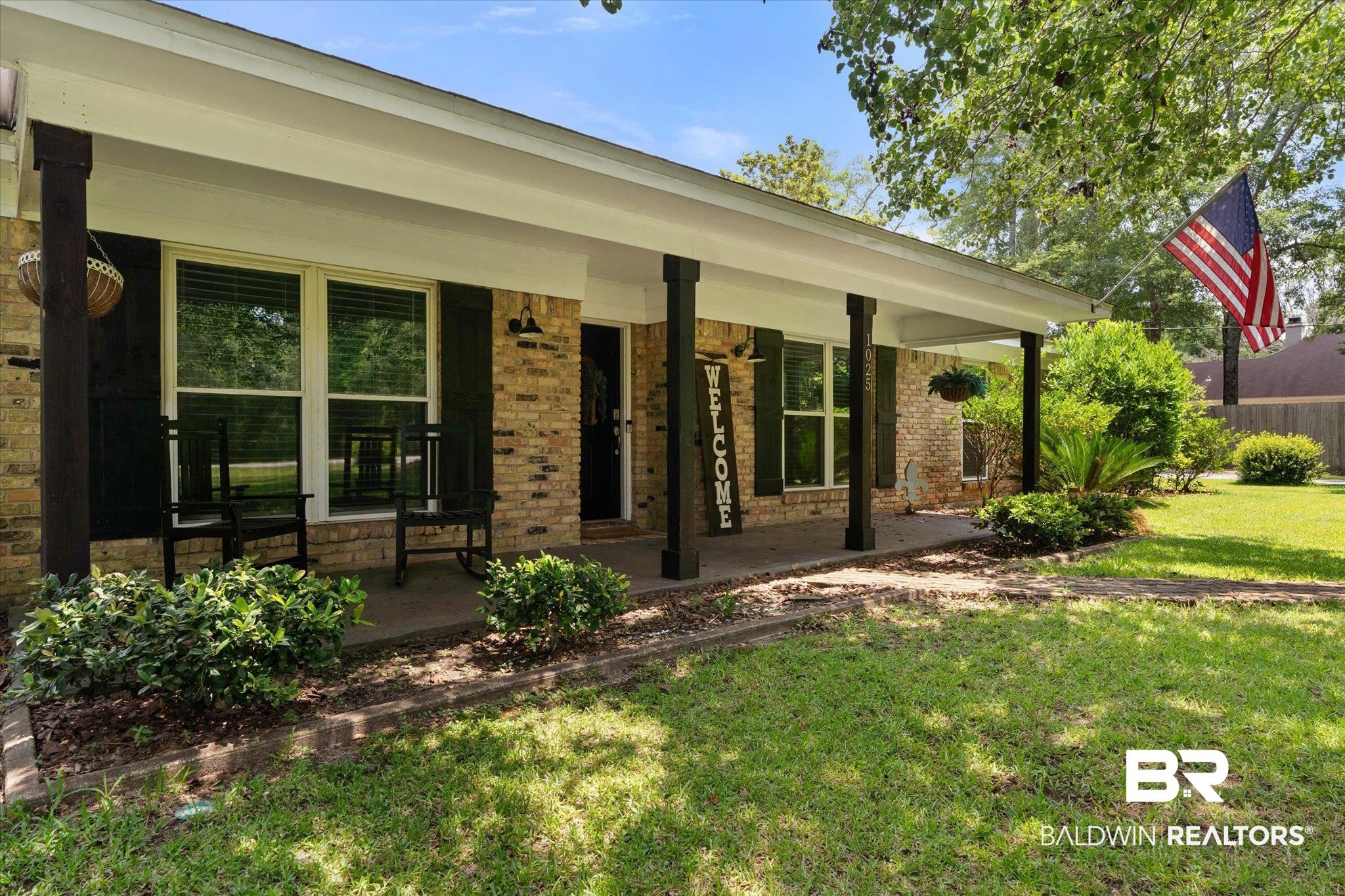 1025 Walter Smith Road Mobile, AL 36695 - Photo 2 of 46 Property entrance featuring a porch, brick siding, and a lawn