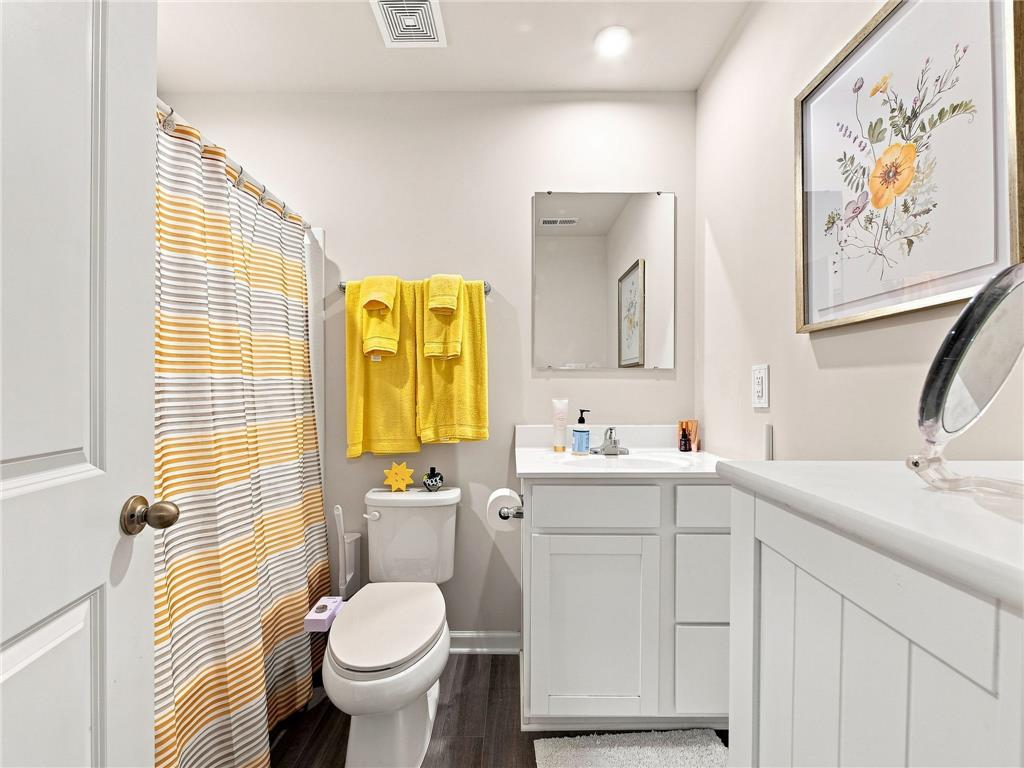 2133 Cross Country Road Northampton, PA 18067 - Photo 37 of 44 An inviting bathroom displays a modern white vanity and crisp cabinetry on dark wood flooring.