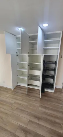 a view of walk in closet with empty racks