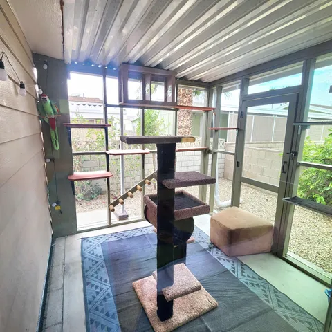 a living room with furniture and a floor to ceiling window