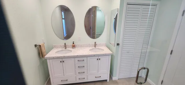 a bathroom with a double vanity sink and a mirror