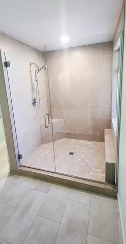 a bathroom with a glass shower door
