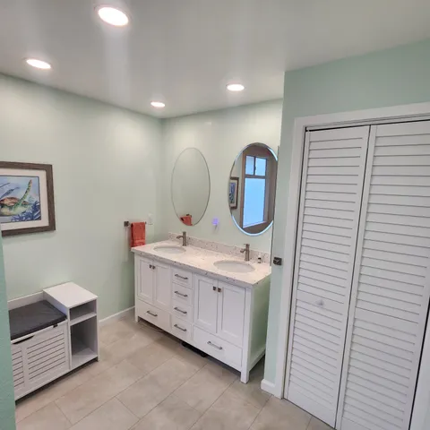 a bathroom with a double vanity sink and a mirror