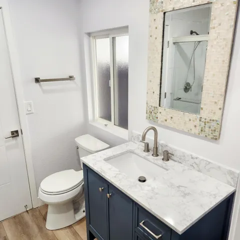 a bathroom with a sink toilet and shower