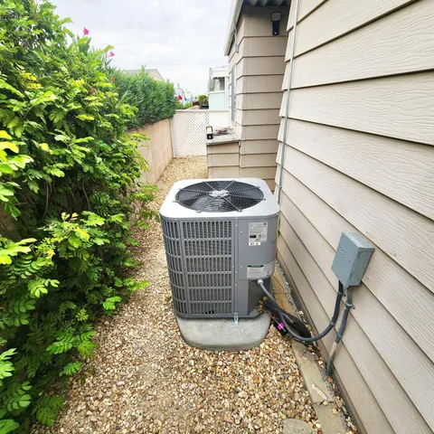 a view of a patio with table and chairs potted plants and large tree