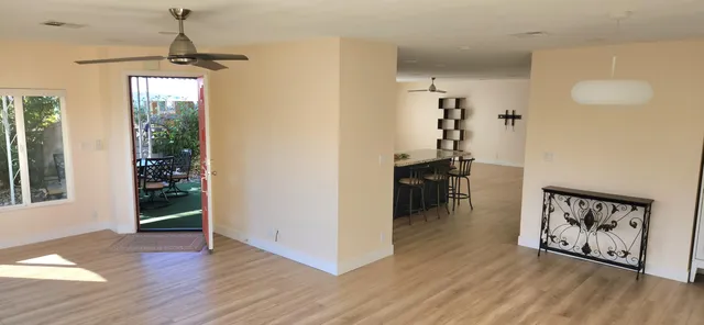 a view of a hallway with wooden floor and staircase