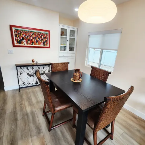 a view of a dining room with furniture and wooden floor