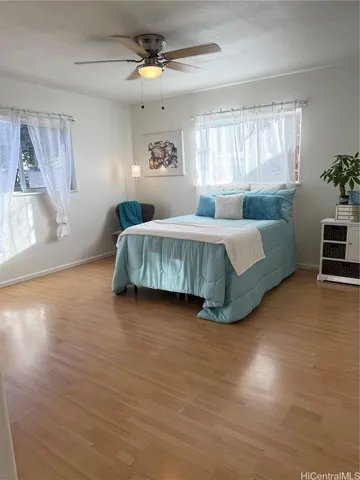 a spacious bedroom with a large bed and a chandelier