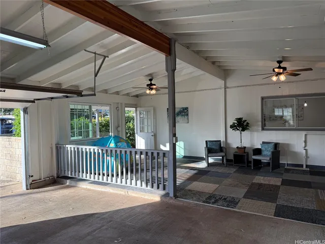 a view of a porch with furniture and a yard
