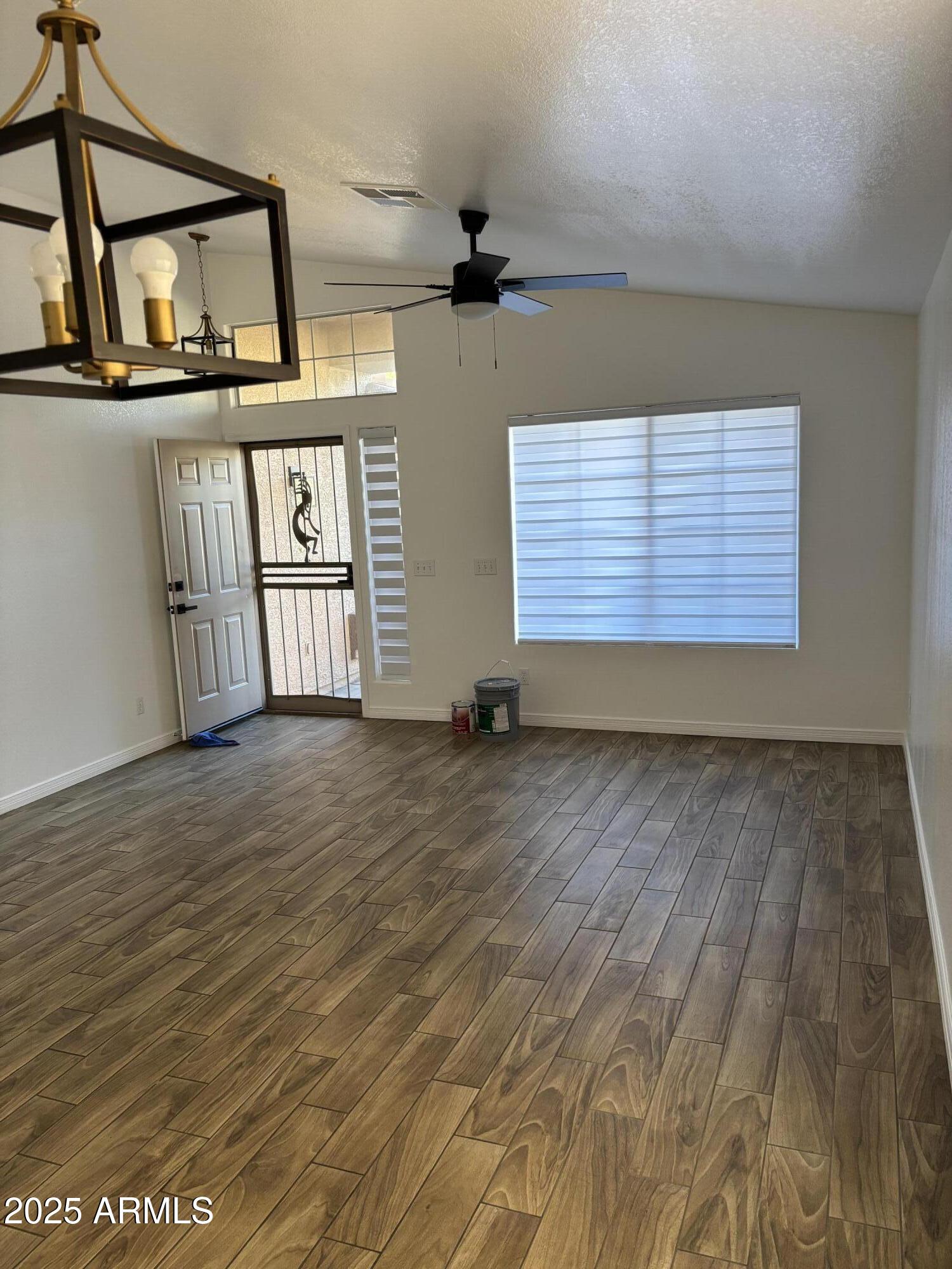 249 West Grovers Avenue Phoenix, AZ 85023 - Photo 5 of 6 a view of an empty room with wooden floor and a window