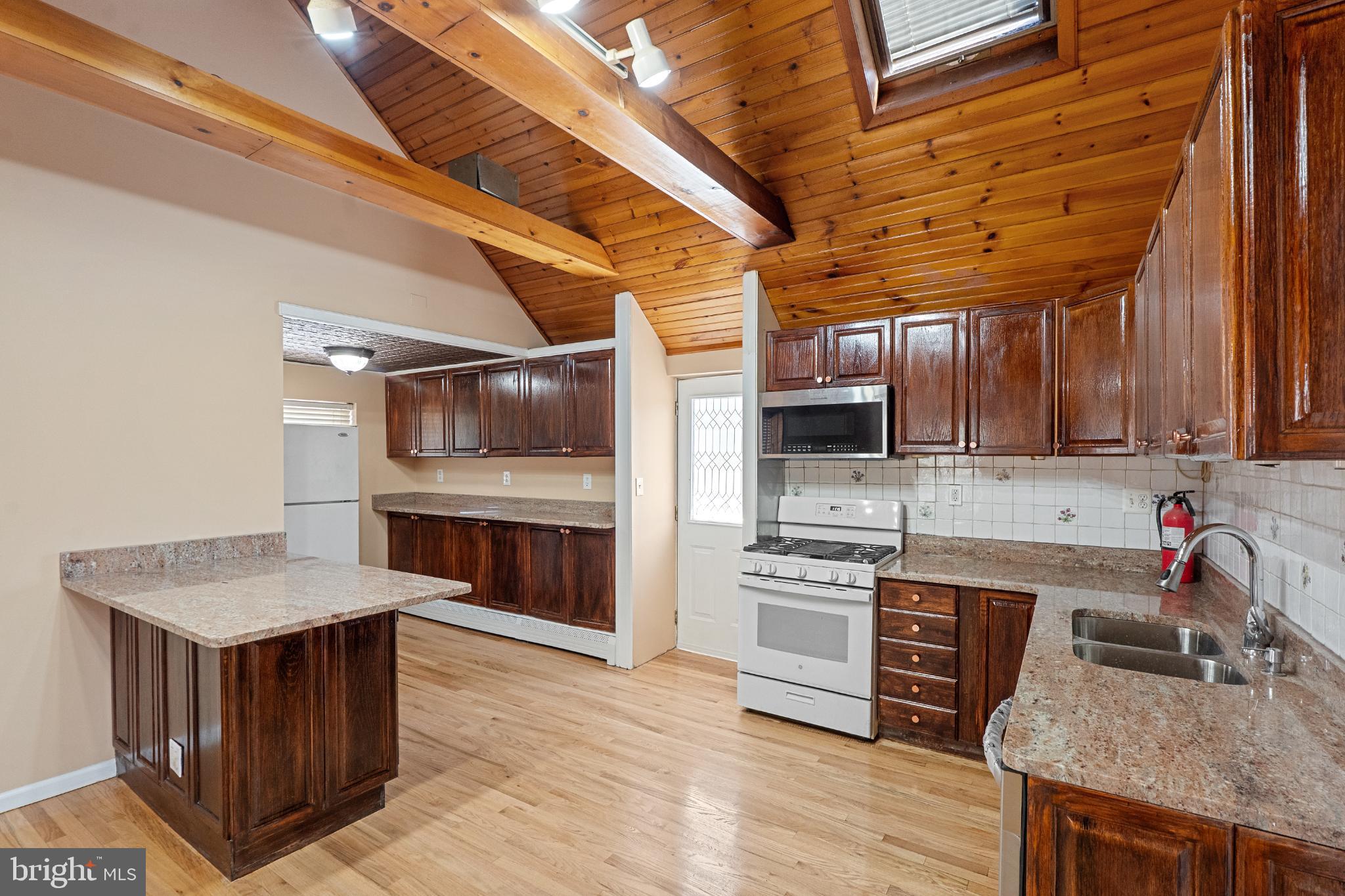 3850 Highway 27 Princeton, NJ 08540 - Photo 13 of 35 a kitchen with a stove cabinets and a wooden floor
