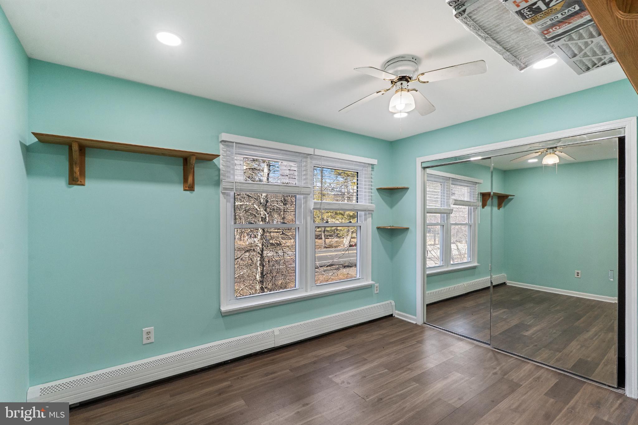 3850 Highway 27 Princeton, NJ 08540 - Photo 18 of 35 an empty room with wooden floor fan and windows