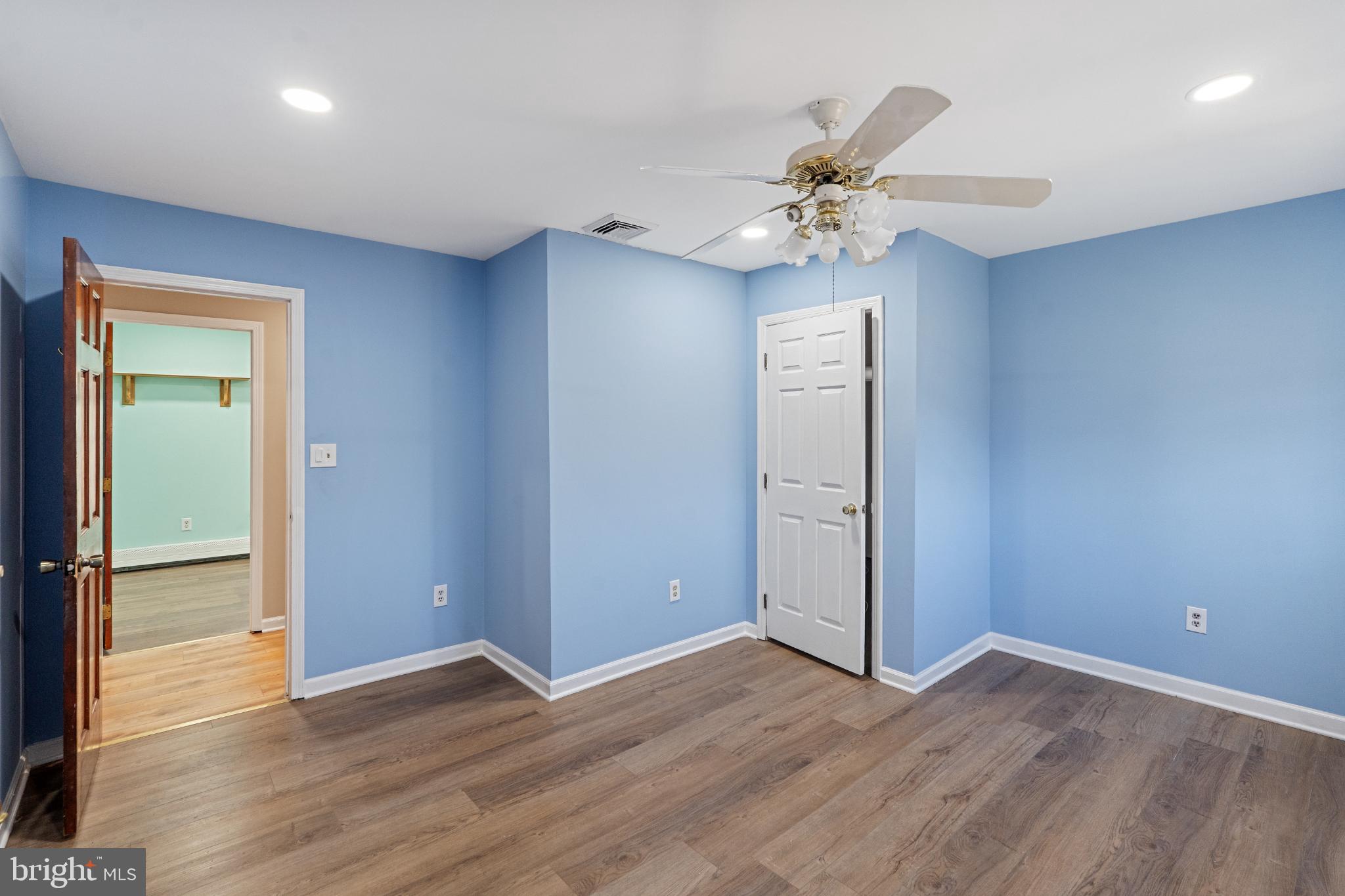 3850 Highway 27 Princeton, NJ 08540 - Photo 20 of 35 an empty room with wooden floor a chandelier fan and windows