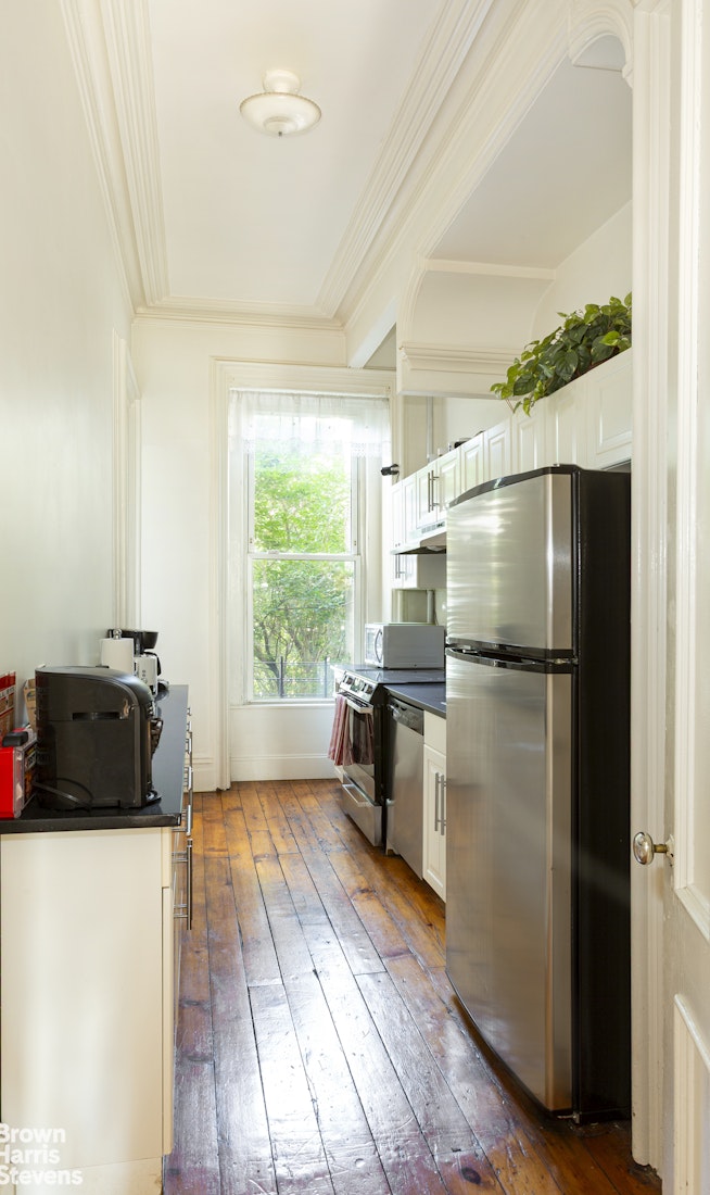 823 Union Street Brooklyn, NY 11215 - Photo 12 of 17 a kitchen with a refrigerator a stove and a wooden floors