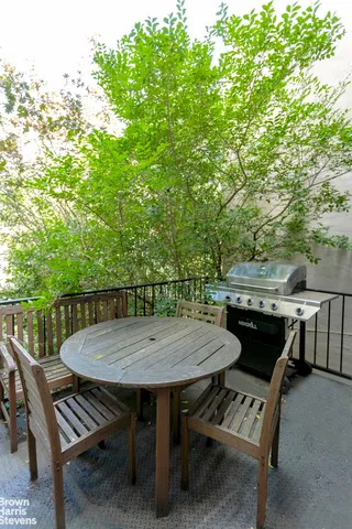 a kitchen with a refrigerator a stove and a wooden floors