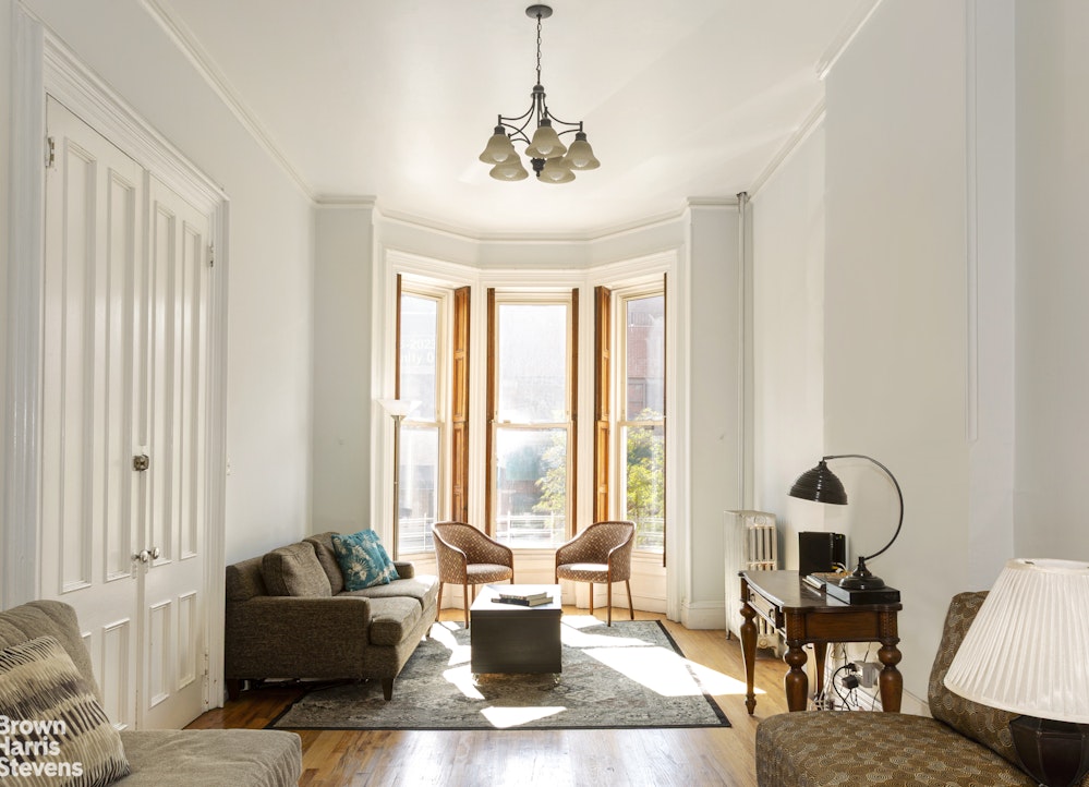 823 Union Street Brooklyn, NY 11215 - Photo 2 of 17 a living room with furniture and floor to ceiling windows