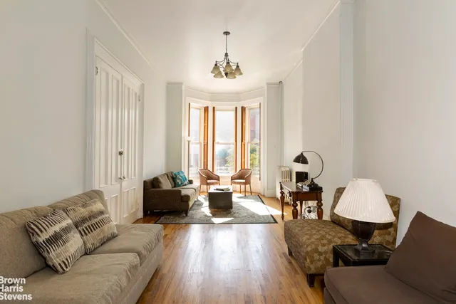 a living room with furniture and floor to ceiling windows