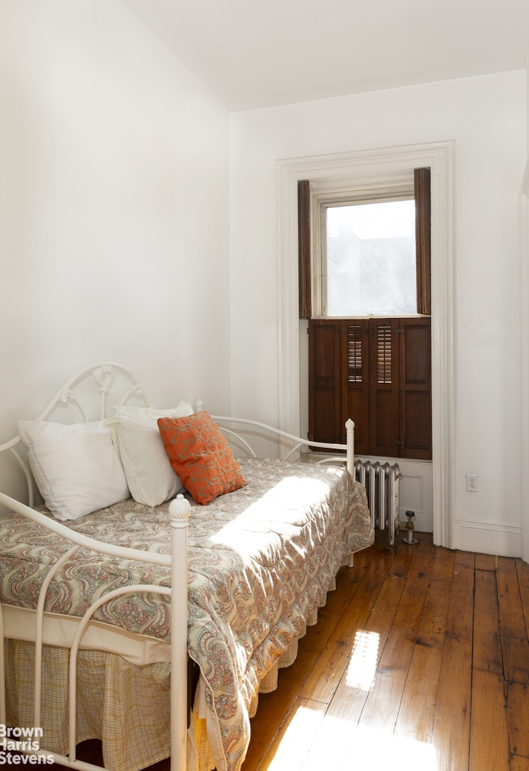 823 Union Street Brooklyn, NY 11215 - Photo 9 of 17 a bedroom with a bed and a window