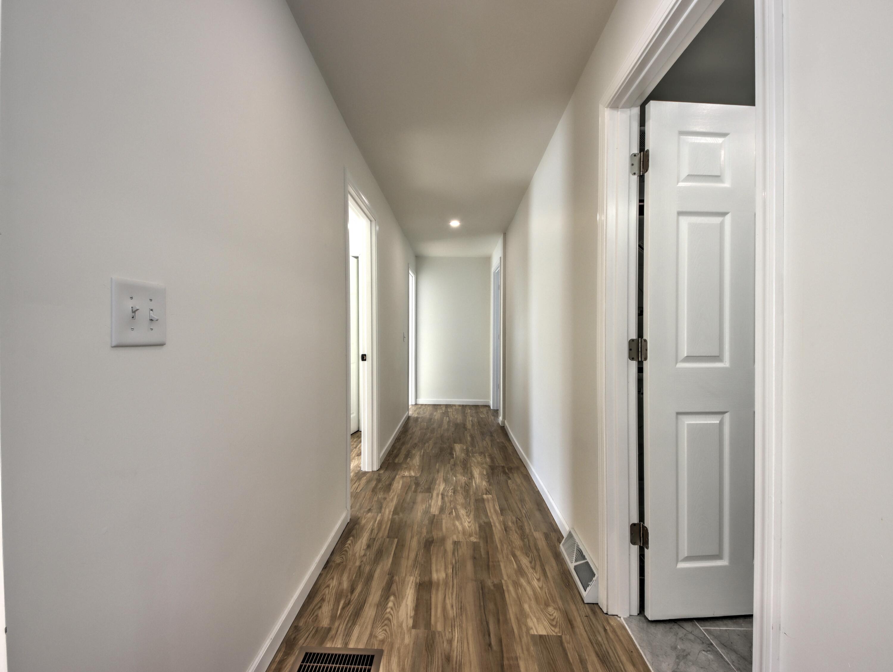315 Holly Drive Walkerton, IN 46574 - Photo 11 of 33 a view of a hallway with wooden floor and entryway