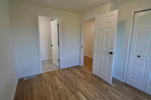 a view of hallway with wooden floor