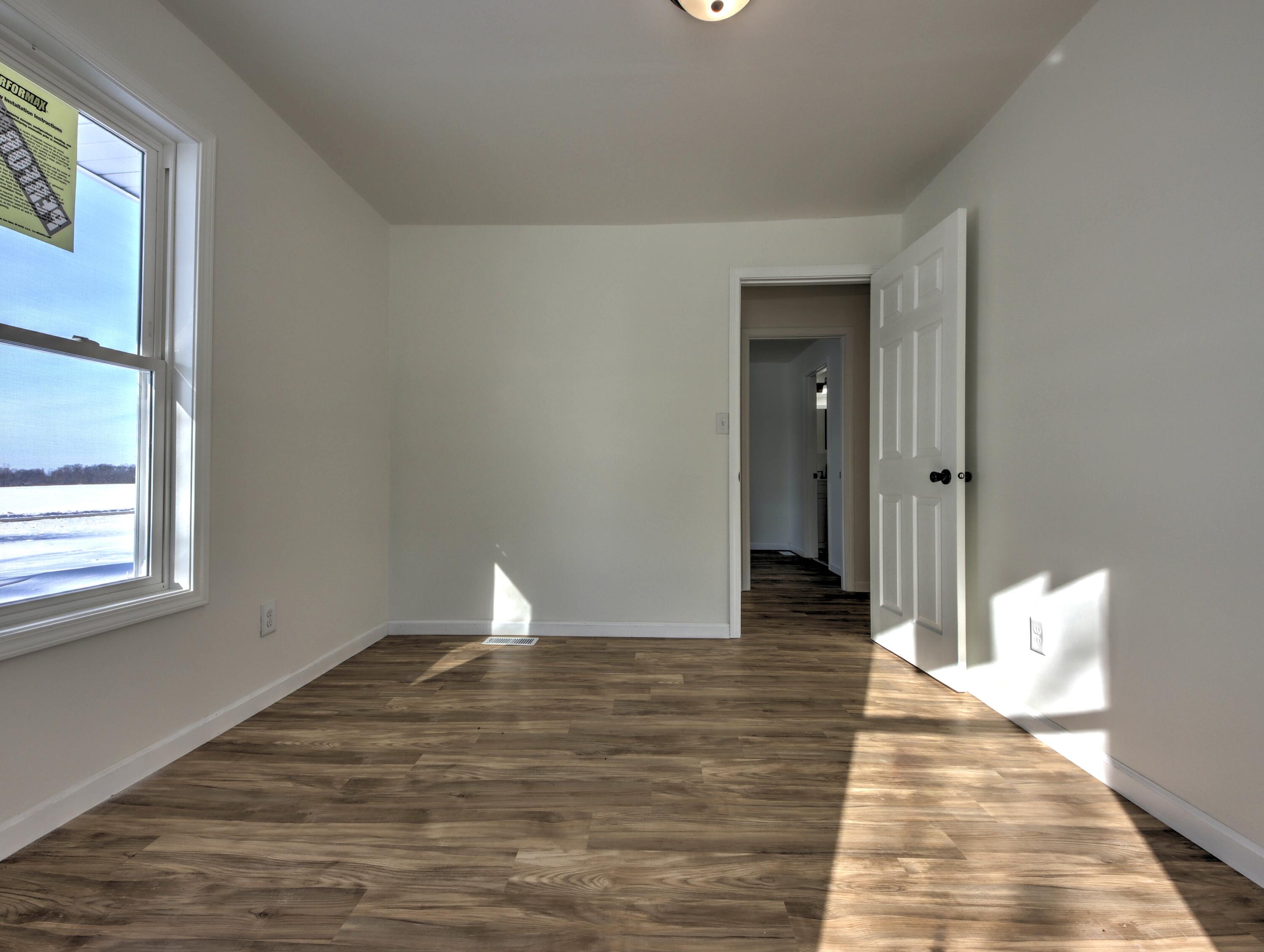 315 Holly Drive Walkerton, IN 46574 - Photo 19 of 33 a view of a room with wooden floor and window