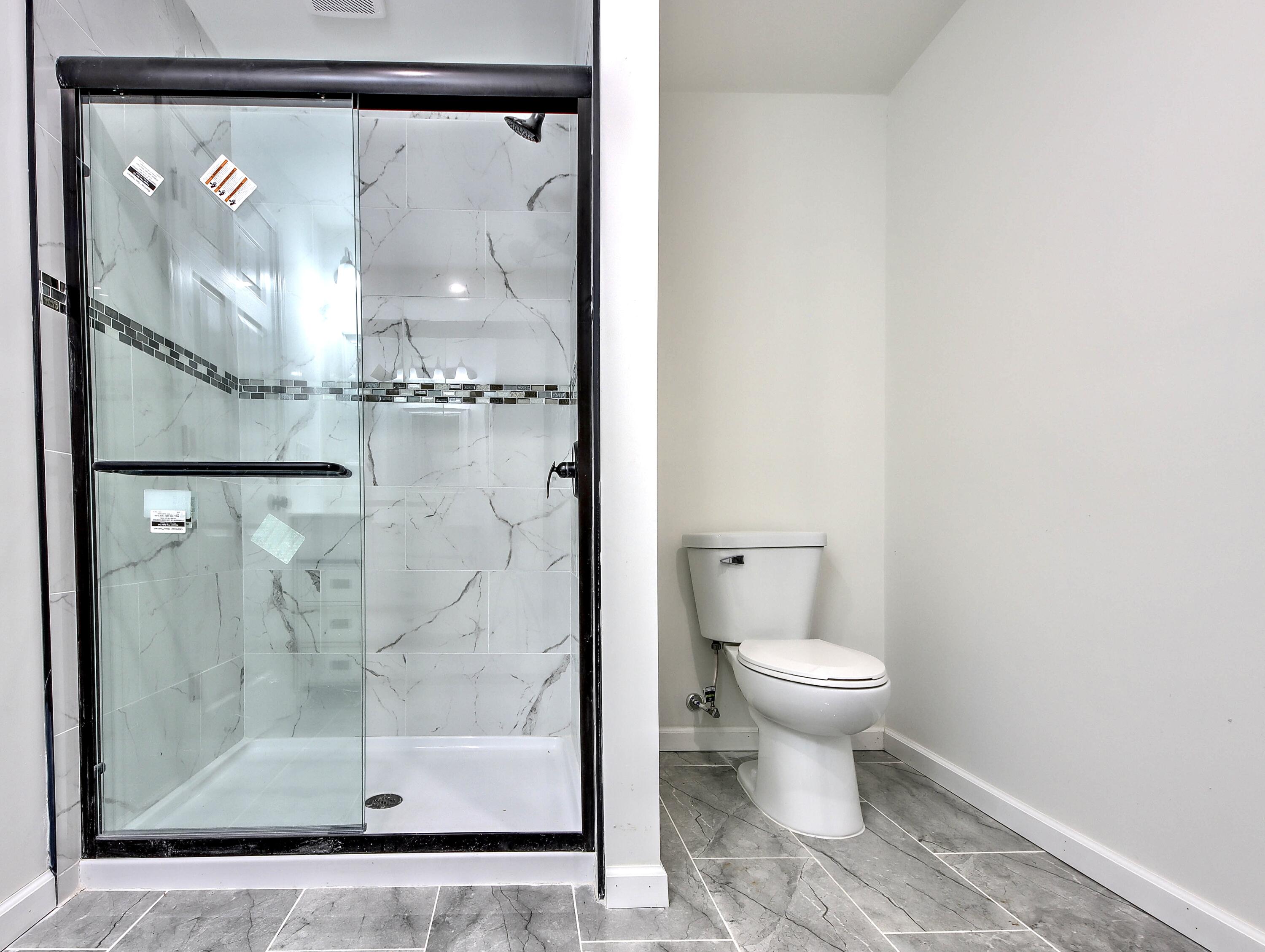 315 Holly Drive Walkerton, IN 46574 - Photo 21 of 33 a bathroom with a glass shower door