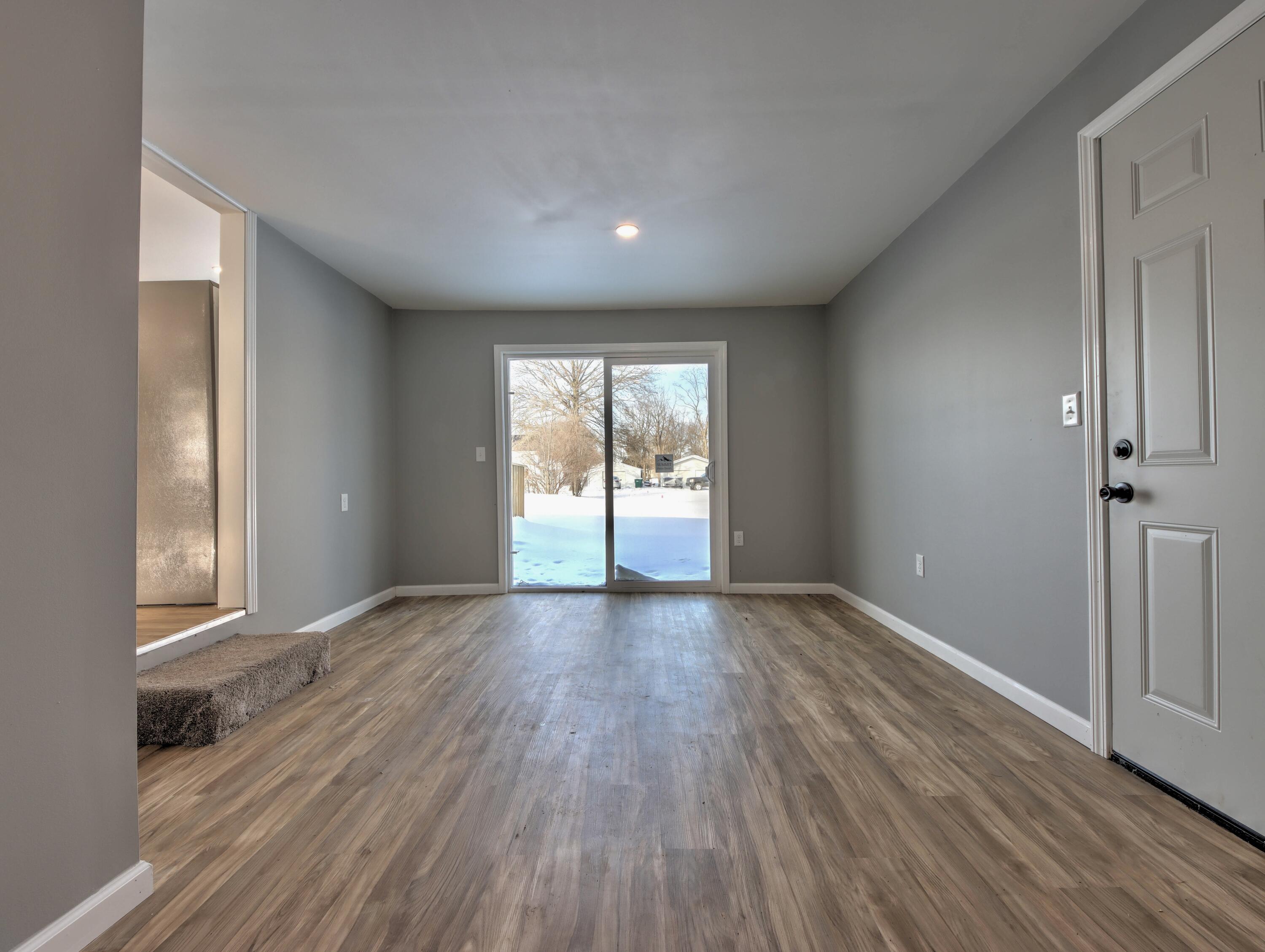 315 Holly Drive Walkerton, IN 46574 - Photo 22 of 33 wooden floor in an empty room with a window