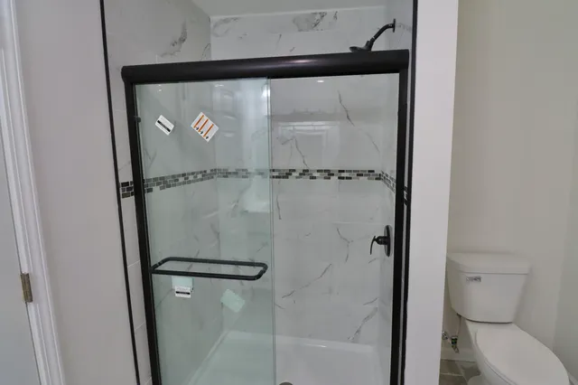 a bathroom with a glass shower door