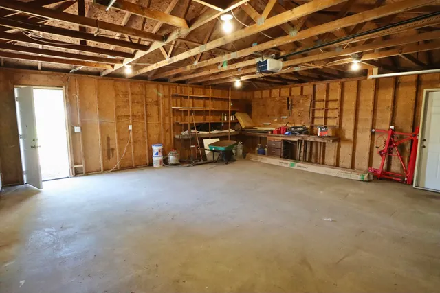 a view of a house with a backyard and floor to ceiling window
